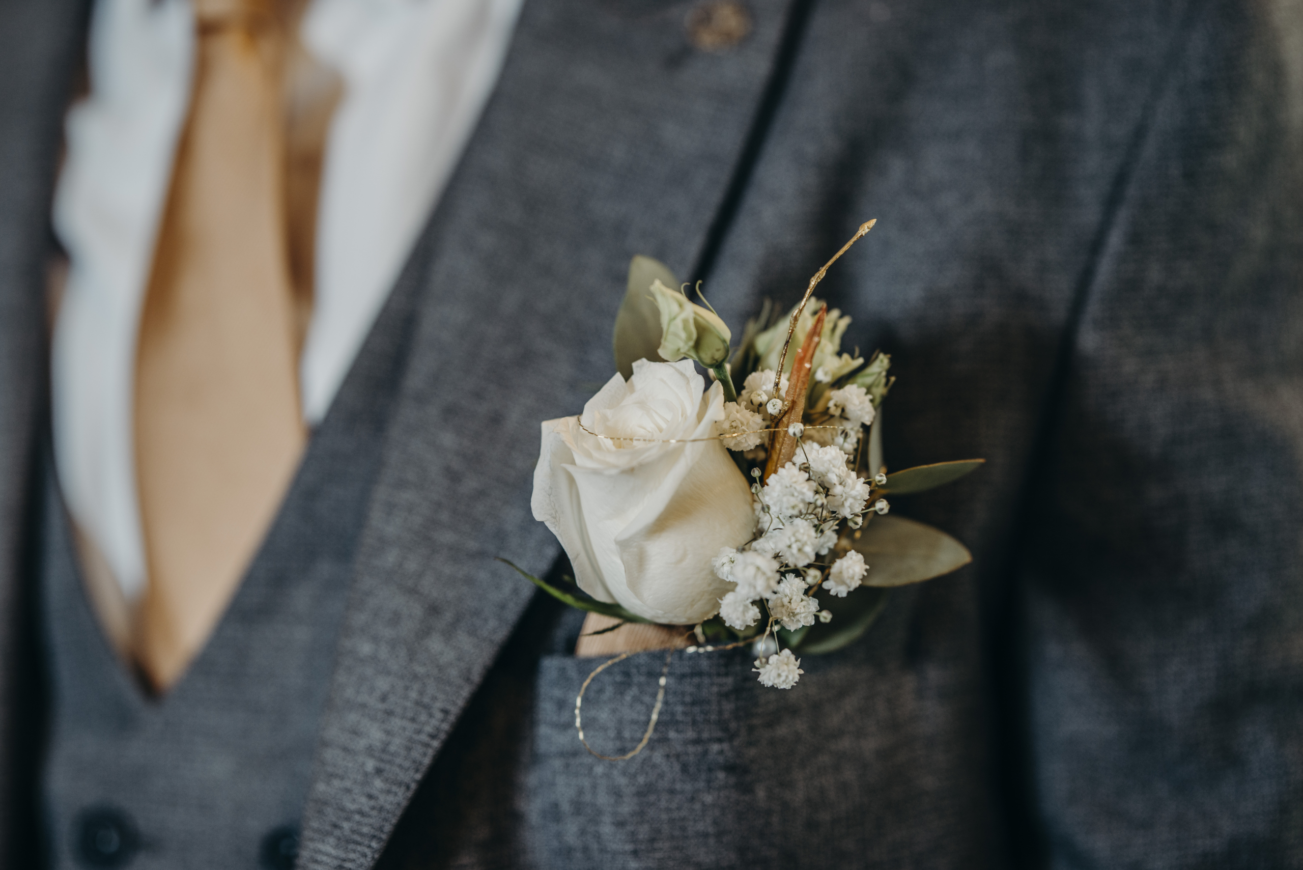 Close-up of elegant wedding buttonhole flowers at Fitzpatrick Castle Hotel styled by Flowerstouch