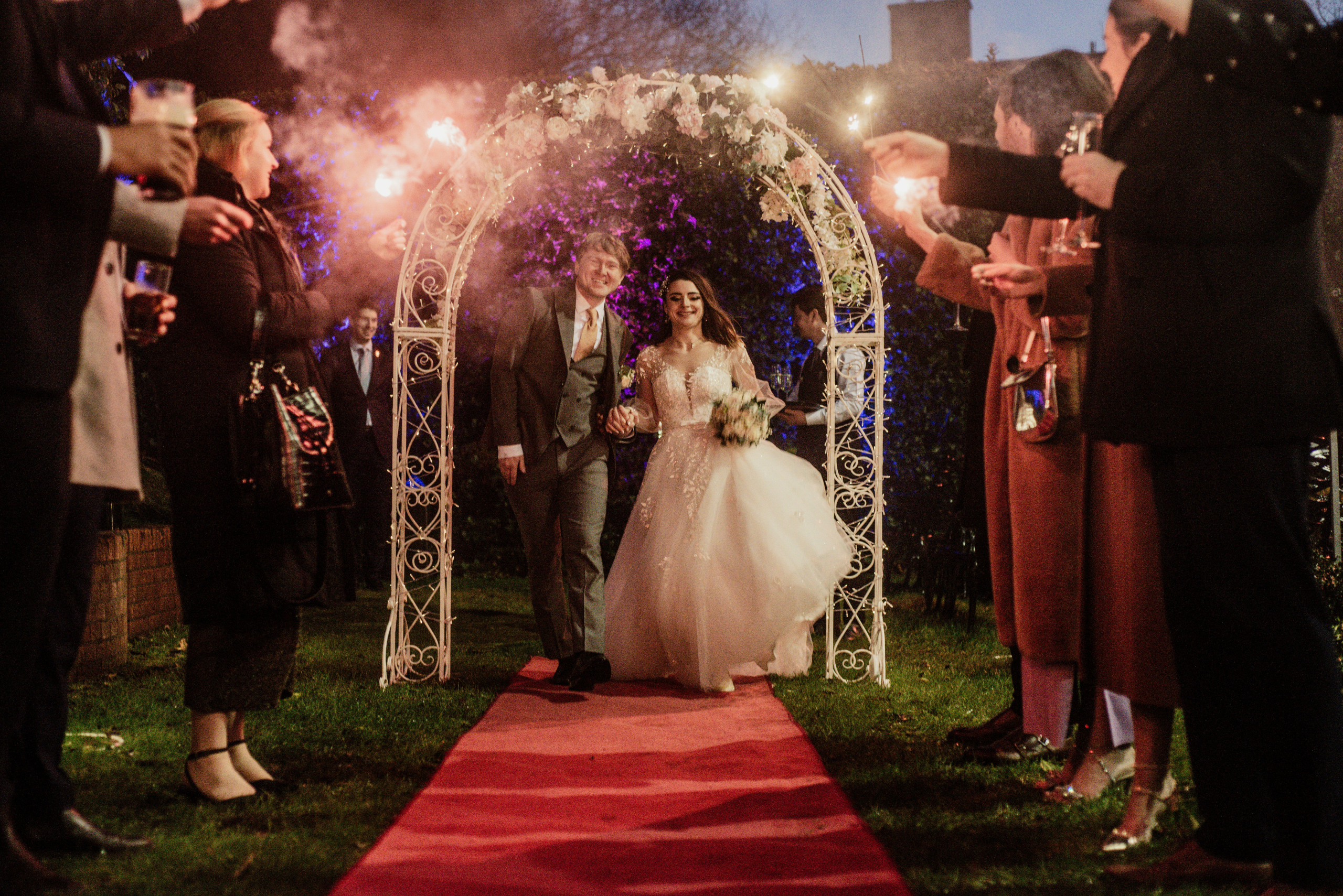 Stunning illuminated floral arch and bridal bouquet for a winter wedding at Fitzpatrick Castle Hotel by Flowerstouch